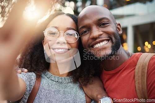 Image of .Selfie, freedom and smile with an interracial couple in the city together for travel, tourism or adventure overseas. Portrait, love or fun with a man and woman taking a photograph in an urban town.