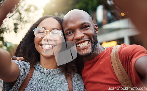 Image of .Selfie, love and smile with an interracial couple in the city together for travel, tourism or adventure overseas. Portrait, freedom or fun with a man and woman taking a photograph in an urban town.