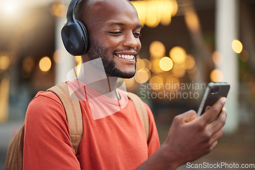 Image of City, headphones and black man with smartphone, typing and connection with social media, audio and streaming music. Outdoor, radio and male person with a cellphone, mobile app and headset with sound