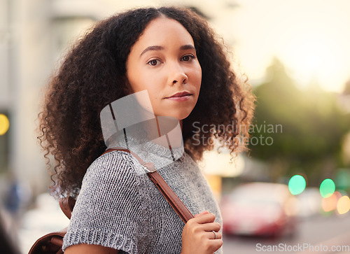 Image of .Young, serious and portrait of a woman in the city waiting for a cab, lift or public transport. Beautiful, confident and headshot of a female person from Mexico walking in an urban town street.