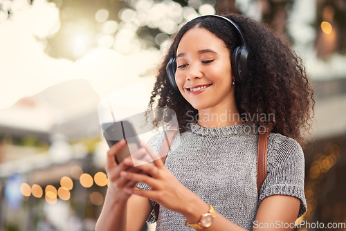 Image of .City, headphones and woman with smartphone, typing and connection with happiness, social media and streaming music. Outdoor, female person and girl with a cellphone, contact and headset with audio.