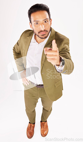 Image of Portrait, pointing and scolding with a business man in studio on a white background for discipline. Manager, finger wag and accuse with a serious young boss telling off an employee for control