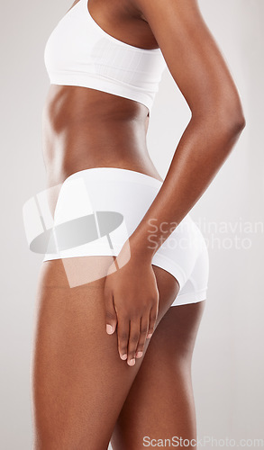 Image of Woman, hands and body in underwear for lose weight, slim or diet against a white studio background. Female person in lingerie for healthy wellness, glutes or buttocks in fitness, skincare or exercise