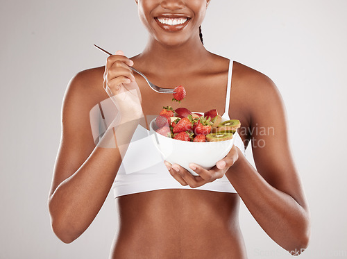 Image of Woman, hands and diet with fruit salad for natural nutrition against a white studio background. Closeup of female person holding bowl of organic strawberry and kiwi to lose weight or healthy wellness