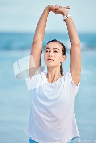 Image of Woman, beach and stretching body in yoga for fitness, exercise or spiritual wellness in outdoor workout. Female person, yogi or runner in warm up on ocean coast for sports, zen or meditation outside