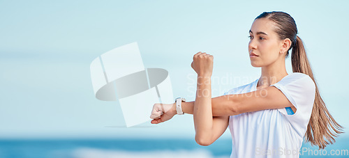 Image of Woman, arm and stretching by beach on mockup space in fitness, motivation or outdoor workout. Female person or runner in body warm up on ocean coast, banner or sports for healthy wellness or training