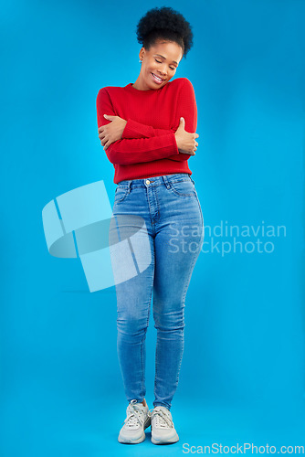 Image of Fashion, smile and portrait of a woman with comfort and confident isolated in a studio blue background. Casual, calm and full body of a happy young female person with stylish or trendy clothes