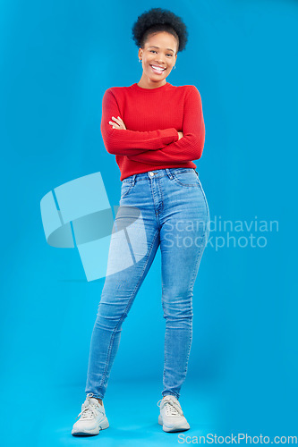 Image of Fashion, smile and portrait of a woman with style and confident isolated in a studio blue background. Casual, outfit and full body of a happy young female person with stylish or trendy clothes