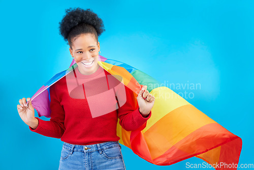 Image of African woman, pride flag and smile in studio, thinking and excited for human rights, equality and inclusion. Girl, student and rainbow fabric for protest, freedom and lgbtq vision by blue background