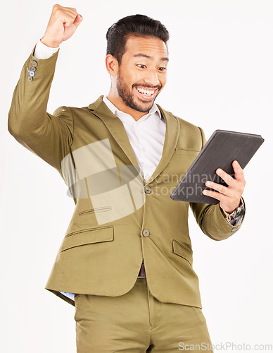 Image of Happy asian man, tablet and fist pump in celebration for winning, discount or sale against a white studio background. Excited businessman with technology in success for good news, bonus or promotion