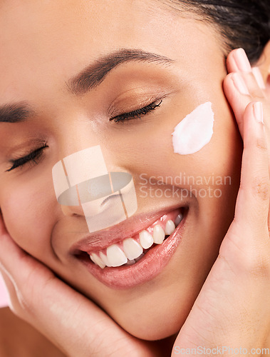 Image of Beauty, cream and face of a happy woman with skin care, dermatology and natural glow. Closeup of a young female aesthetic model with a smile for moisturizer, cosmetics or sunscreen for wellness