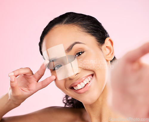 Image of Selfie, peace hand sign and happy woman in studio with natural beauty, wellness and cosmetics. Portrait, female person and pink background with makeup and face with skincare and emoji gesture of girl