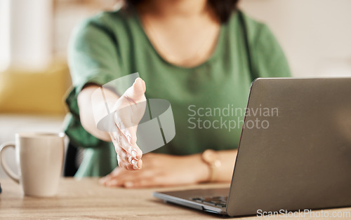 Image of Handshake, remote work and person hand with laptop, greeting and welcome in a home. House, computer and shaking hands gesture for deal, agreement and thank you for online job and introduction at desk
