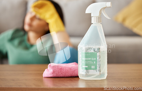 Image of Cleaning, tired and woman with spray bottle in living room for , housework and maid service. Furniture, housekeeping and exhausted, fatigued and burnout female person with detergent products for dirt