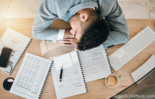 Image of Top view, burnout and tired or man with sleeping at desk and exhausted at finance job. Employee, depressed and rest on table at work with fatigue or accountant with stress in office with documents.
