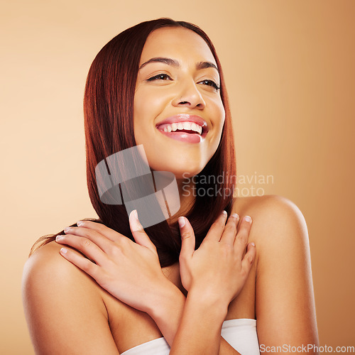Image of Hair care, natural beauty and happy woman with hands on skin, glow and luxury salon treatment on brown background. Smile, haircut and haircare, face of model with cosmetics and makeup shine in studio