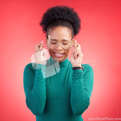 Image of Fingers crossed, praying and black woman in studio with good luck sign for bonus, prize or giveaway on red background. Hope, wish and African lady with pray emoji for waiting, reward or lotto results