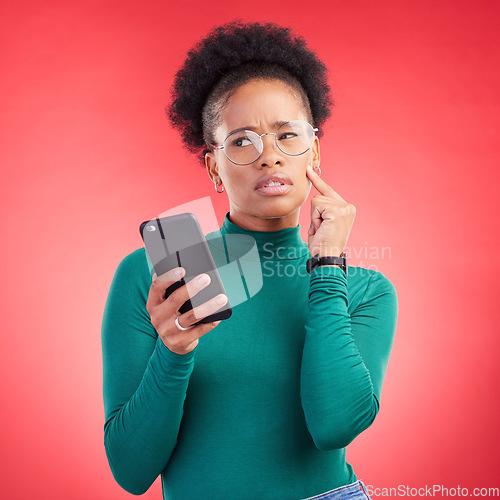 Image of Thinking, phone and black woman in studio confused by text, application or how to steps on red background. Doubt, why and African person with questions for scam or spam contact on smartphone