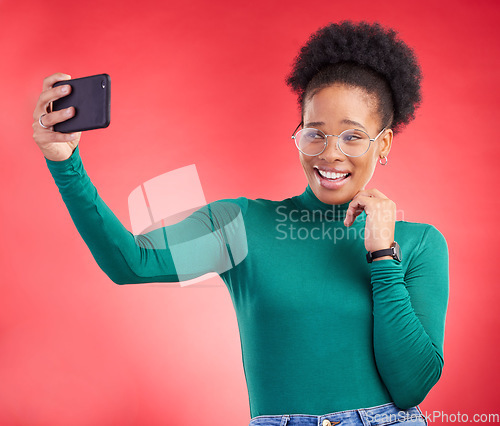 Image of Selfie, smile and black woman in studio for profile picture, post or message on red background. Happy, photo and African female with memory on social media, dating app or online communication update