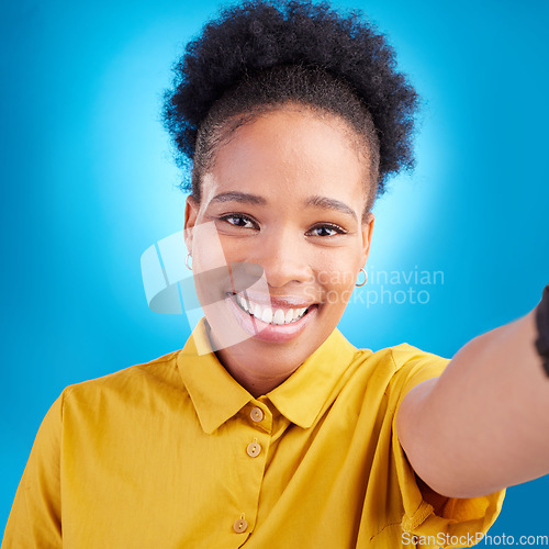 Image of Happy woman, face and portrait smile for selfie, photography or memory against a blue studio background. African female person or photographer smiling for picture, photo or online social media post
