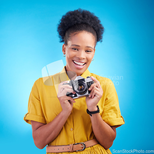 Image of Photography, portrait and black woman with camera, smile and isolated on blue background, creative artist job and talent. Art, face of happy photographer with hobby or career in studio for photoshoot