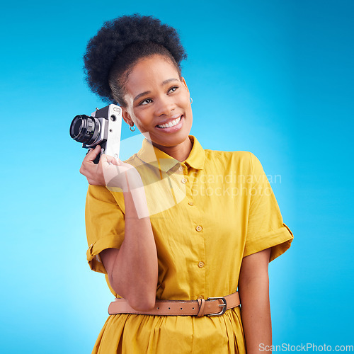 Image of Photography, smile and black woman with camera isolated on blue background, creative artist job and talent. Art, face of happy photographer with hobby or career in studio on travel holiday photoshoot