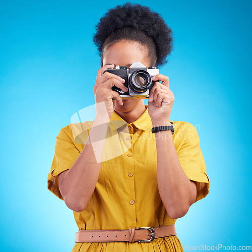 Image of Photography, travel and black woman with camera isolated on blue background, creative artist job and talent. Art, face of photographer with hobby or career in studio taking picture for photoshoot.