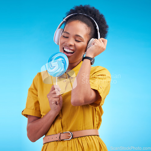 Image of Music, singer and lollipop with black woman and headphones for streaming, audio and media. Radio, technology and freedom with female person on blue background for listening, sound and podcast