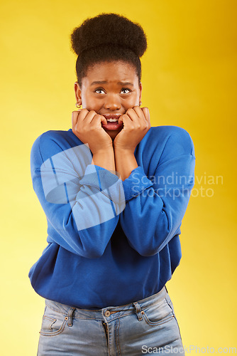 Image of Anxiety, fear and black woman biting nails in studio with terror, guilt and shocking drama on yellow background. Stress, gossip and African female with horror, fake news or worried about secret