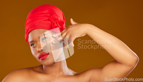 Image of Woman, face touch and hair scarf with natural beauty, makeup and haircare in studio. Brown background, African female person and cosmetics of a model with head wrap for culture with skincare glow