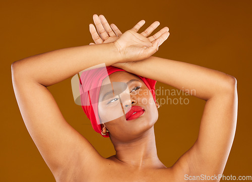 Image of Beauty, makeup and headscarf with face of black woman in studio for facial, creative and pride. Skincare, salon and natural with female model on brown background for wellness, self care and glow