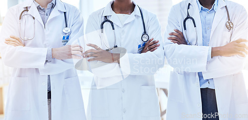 Image of Doctors, team and arms crossed with health, medical group and cardiology and surgeon collaboration in hospital. Confidence, solidarity in cardiovascular healthcare and professional people in medicine