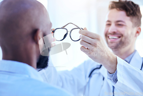 Image of Glasses, optometrist and patient with men in clinic, vision and prescription lens with frame, choice and test. Eyesight, eye care and optometry, health and male people with decision for spectacles