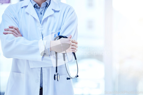 Image of Stethoscope in hand, health and doctor with arms crossed, medical person and cardiology and surgeon in hospital. Mockup space, cardiovascular healthcare and professional expert in medicine at clinic