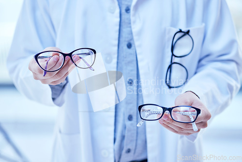 Image of Glasses, choice and optometrist, hands and vision with eyewear in clinic, prescription lens with designer frame. Eyesight, eye care and optometry, healthcare and person with decision for spectacles