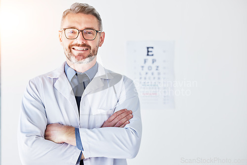 Image of Senior man, optometrist and portrait, arms crossed and smile, eye care clinic and healthcare with vision. Male person, ophthalmology and health for eyes, eyesight assessment and prescription glasses