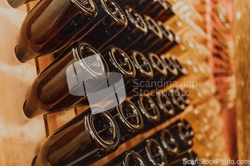 Image of Wine or cognac barrels in the cellar of the winery, Wooden wine barrels in perspective. Wine vaults.Vintage oak barrels of craft beer or brandy.