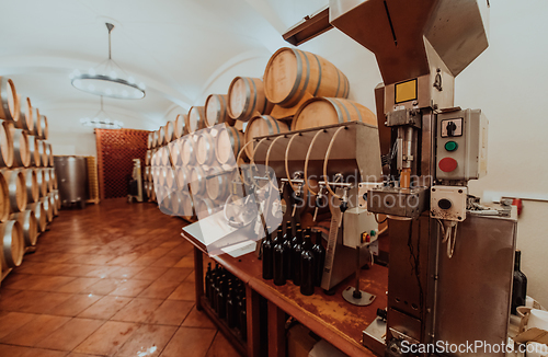 Image of Wine or cognac barrels in the cellar of the winery, Wooden wine barrels in perspective. Wine vaults.Vintage oak barrels of craft beer or brandy.