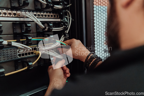 Image of Close up of technician setting up network in server room