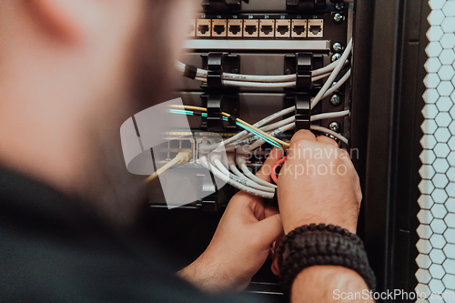 Image of Close up of technician setting up network in server room