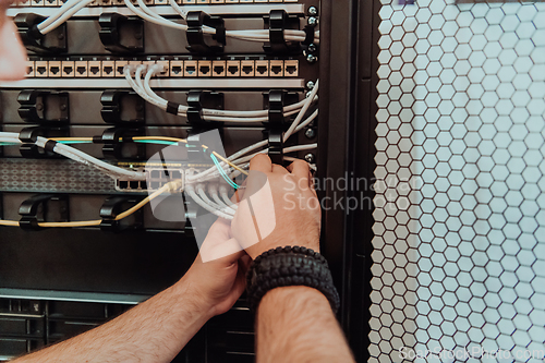 Image of Close up of technician setting up network in server room