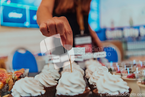 Image of Business woman takes delicious food from the table while in the conference room