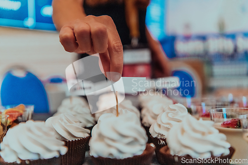 Image of Business woman takes delicious food from the table while in the conference room