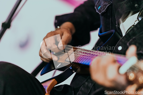 Image of Practicing in playing guitar. Handsome young men playing guitar