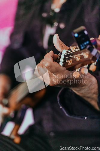 Image of Practicing in playing guitar. Handsome young men playing guitar