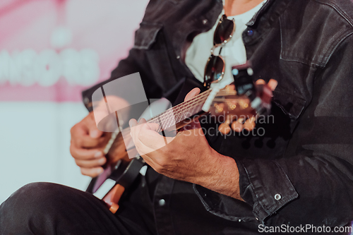 Image of Practicing in playing guitar. Handsome young men playing guitar