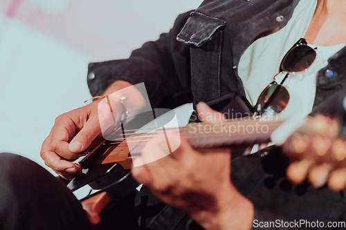 Image of Practicing in playing guitar. Handsome young men playing guitar