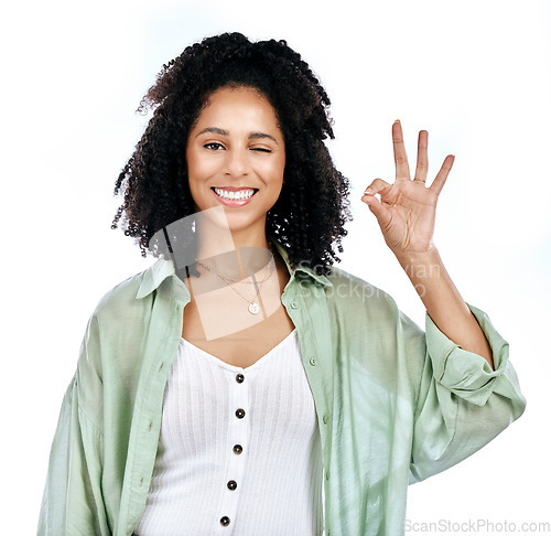 Image of Studio, wink and woman portrait with perfect hand sign for support or agree, vote or review on white background. Face, smile and emoji yes by lady with ok, approval or like, thank you or feedback