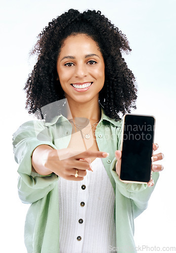 Image of Screen, mockup or portrait of happy woman with phone on white background on social media or product placement. Pointing, smile or person showing mobile app website or tech mock up space in studio