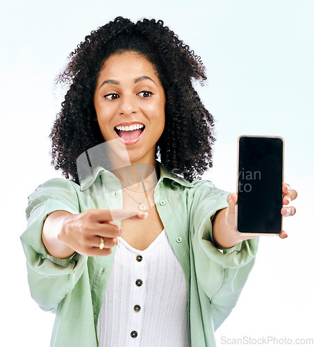 Image of Screen, mockup or woman excited by phone on white background on social media or product placement. Pointing, smile or happy person showing mobile app promo, website or tech mock up space in studio